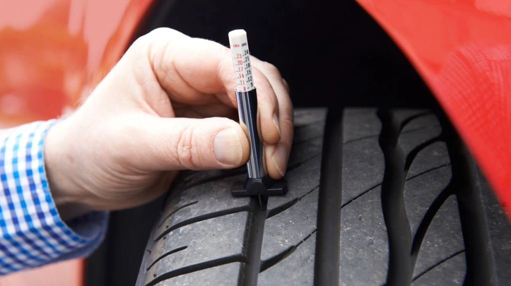 Checking tyre tread depth before an MOT test